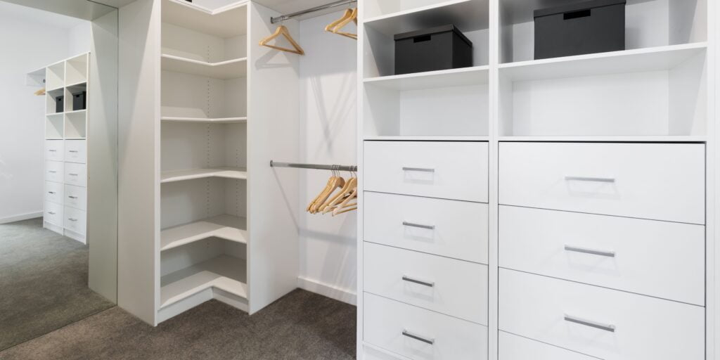 Clean white wardrobe of soft-close system for minimising the risk of accidental injuries