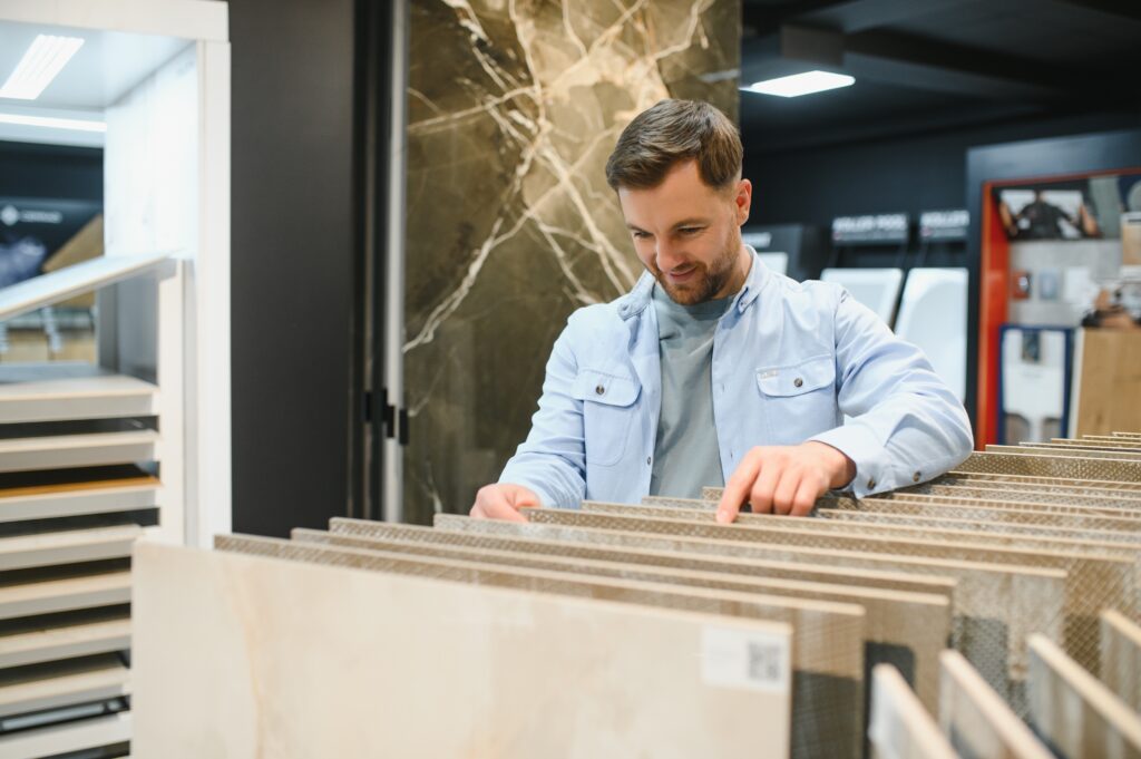 man is selecting tiles for tiles installation for his new house 